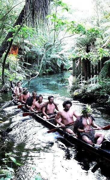 Warriors in a war canoe, Mitai Maori Village, New Zealand